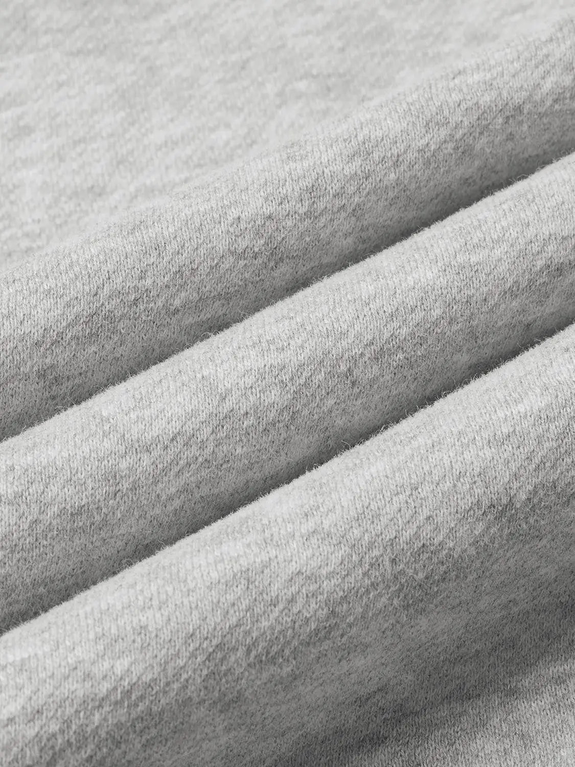 Barrel-leg pants fabric close-up in light gray fleece-knit material.