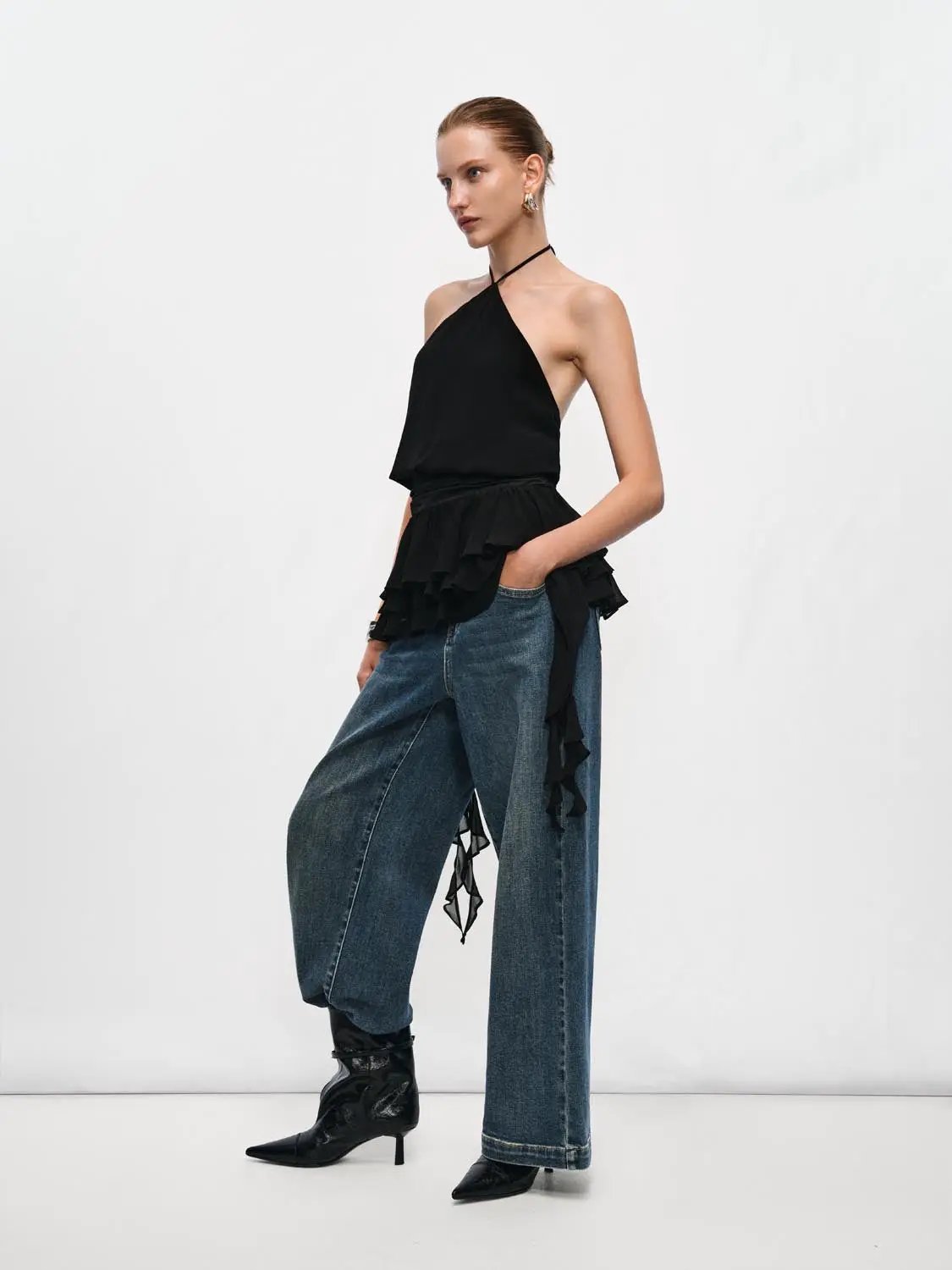 Black halter-neck evening A-line dress with tiered ruffle peplum detail.