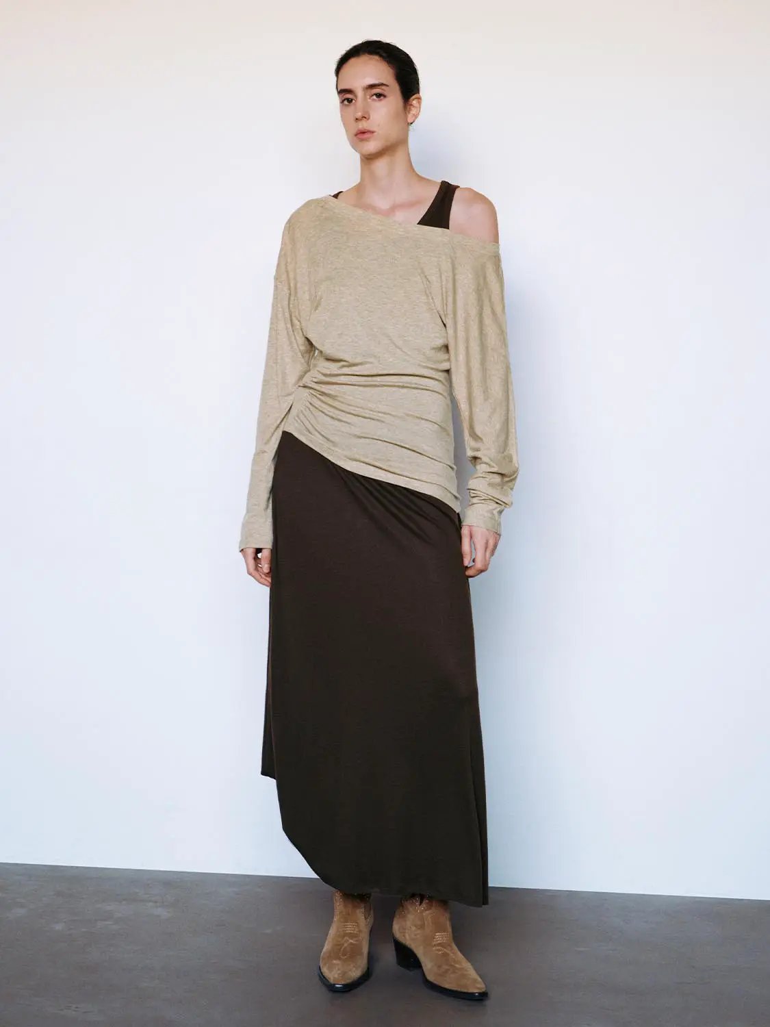 Ruched asymmetric long-sleeve A-line maxi dress in beige with brown skirt, on model