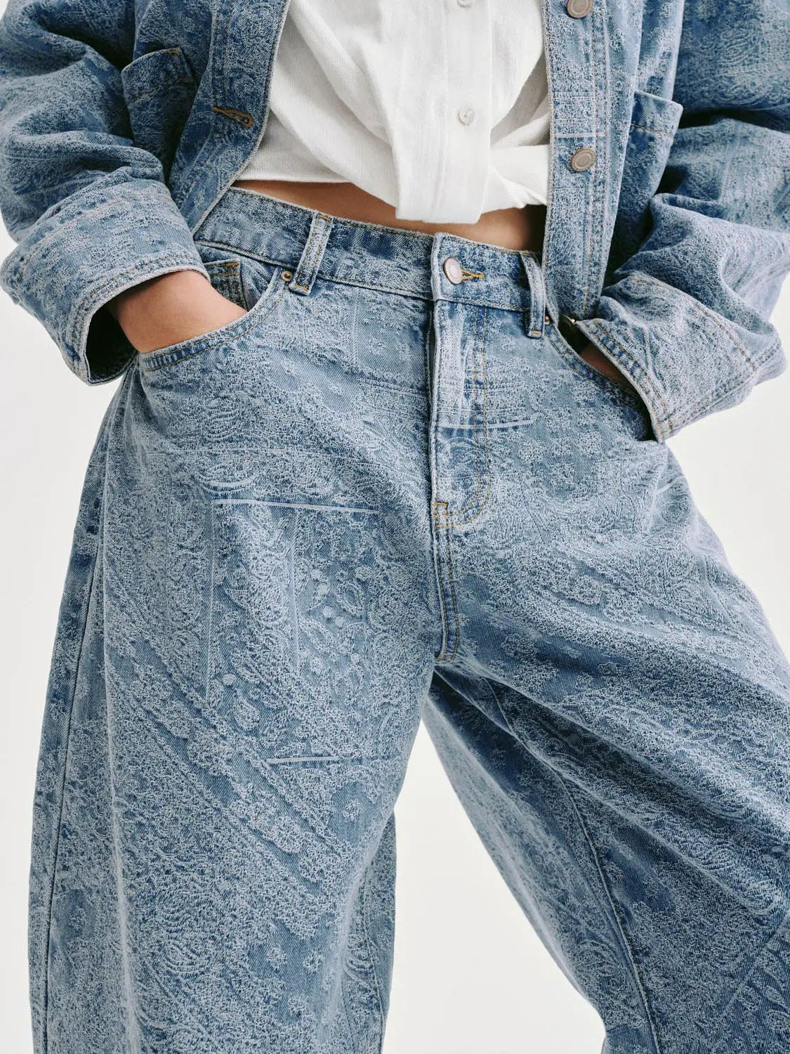 Denim jeans with a light blue floral jacquard pattern and classic five-pocket styling
