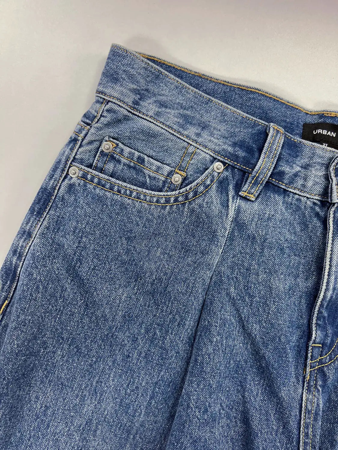 Jeans by Urban Revivo Fashion, blue denim with metal rivets and visible yellow stitching