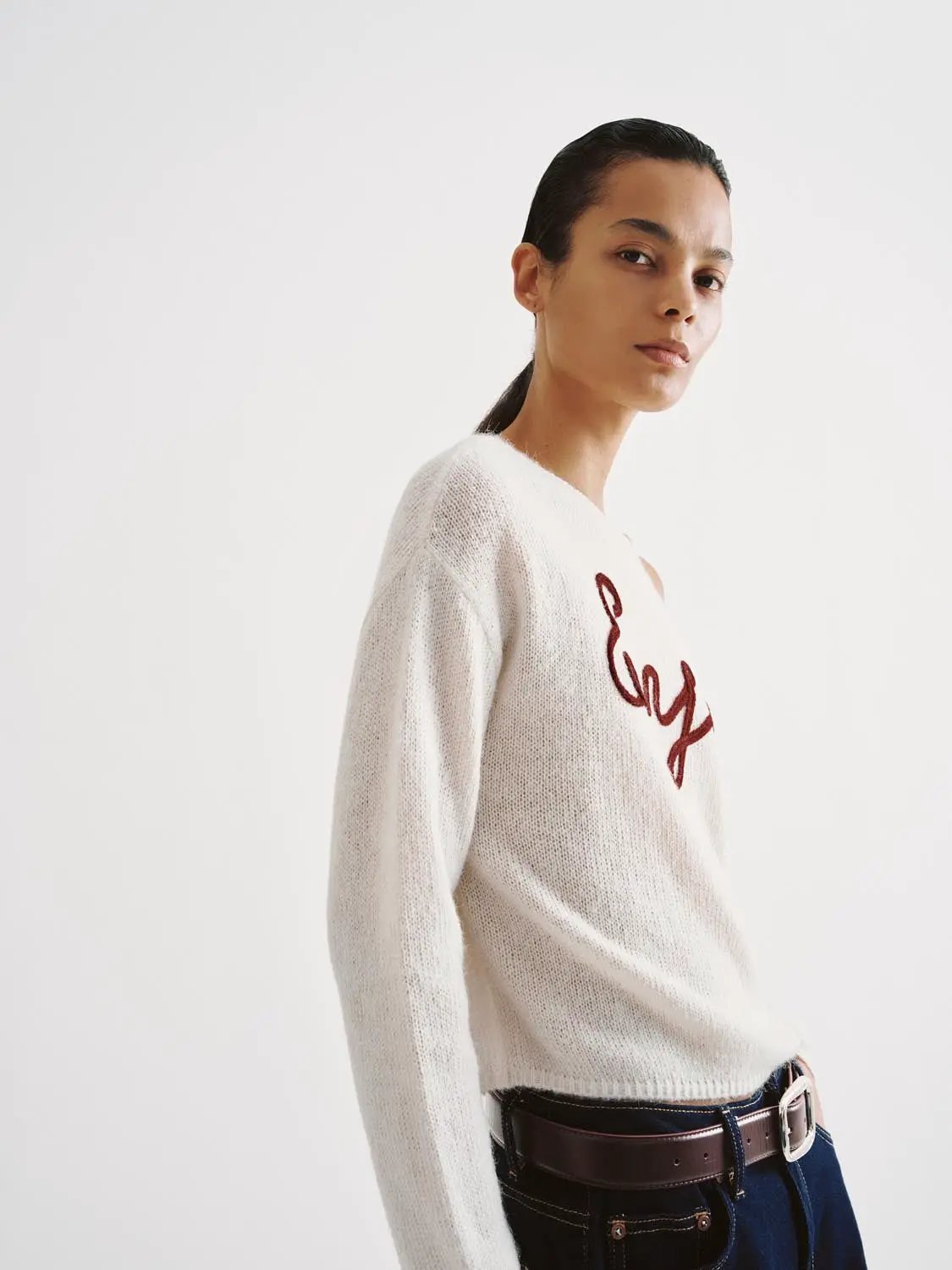 Knit lightweight white sweater with red script embroidery