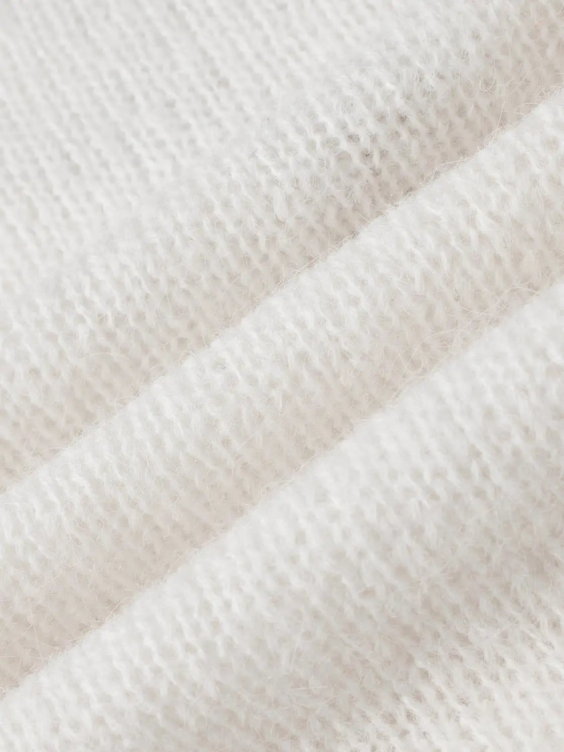 Cream knit lightweight sweater fabric close-up with soft, fuzzy texture