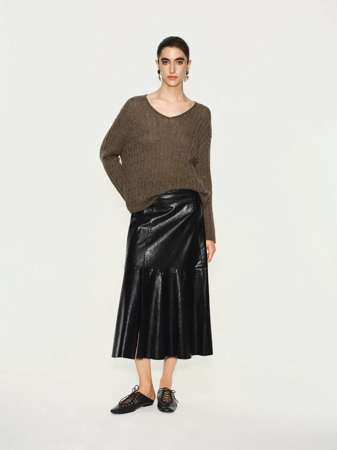 Textured long-sleeve v-neck knit T-shirt in brown, paired with black leather midi skirt