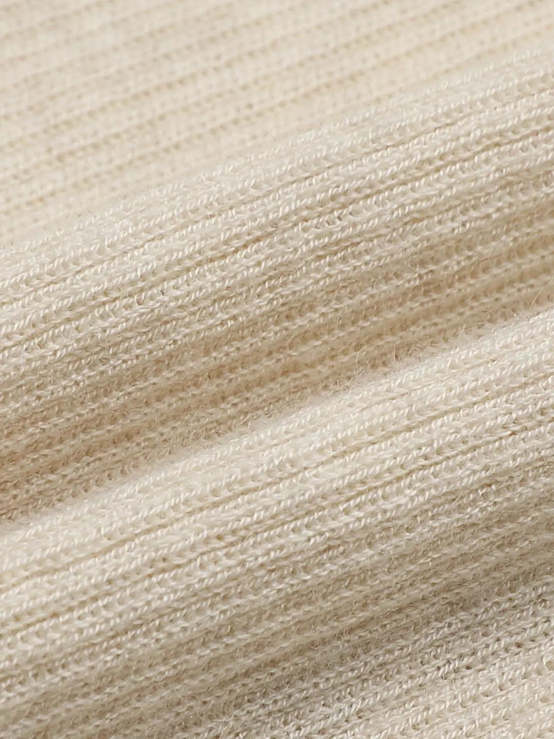 Knit Top beige knitted fabric close-up showing textured yarn