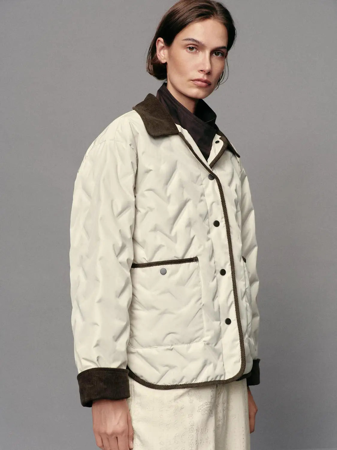 Down Jacket with cream quilting, brown corduroy collar and cuffs, front snap closure