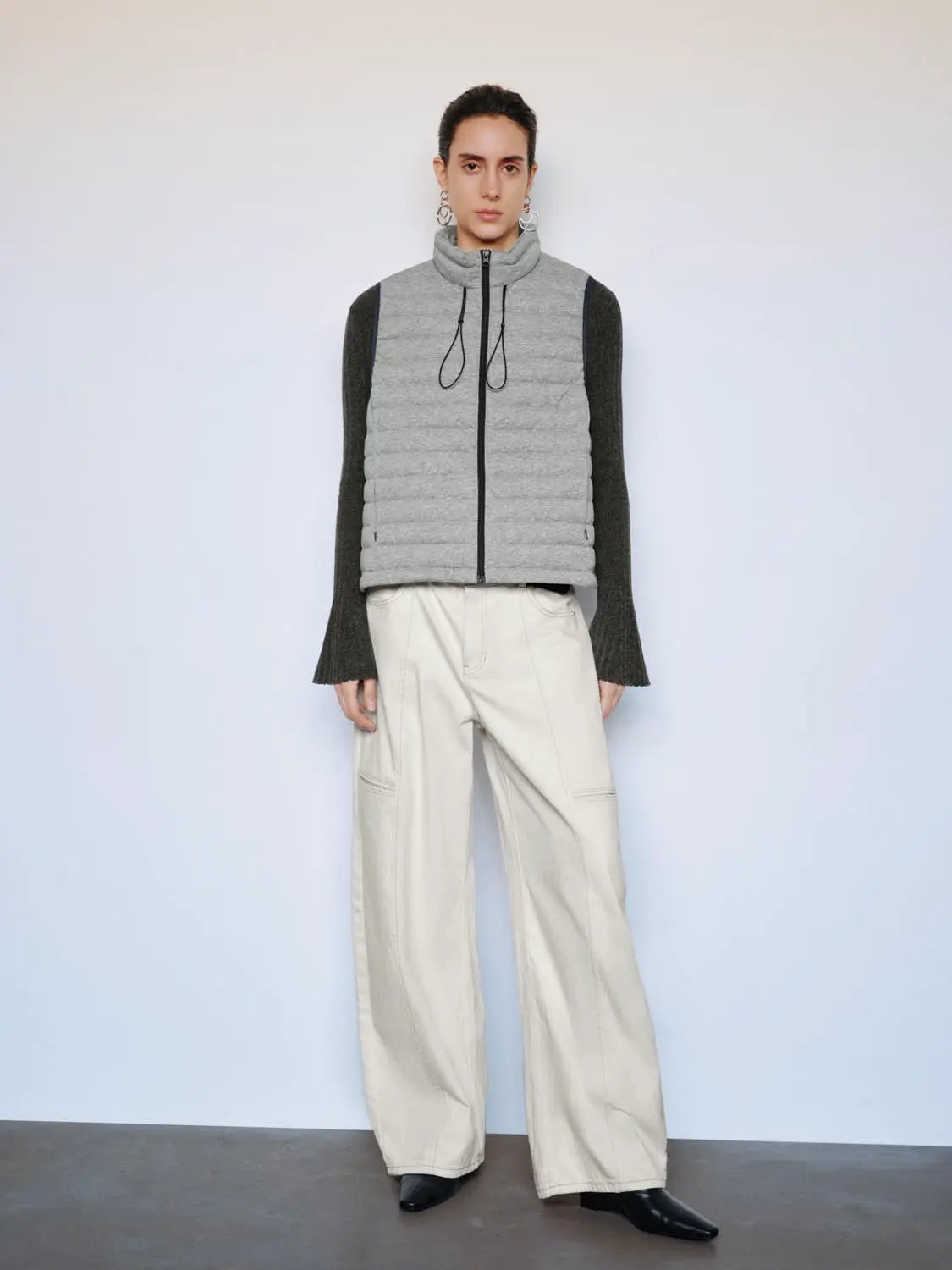 Down jacket by Urban Revivo Fashion in light grey quilted fabric with black front zipper and drawstrings.