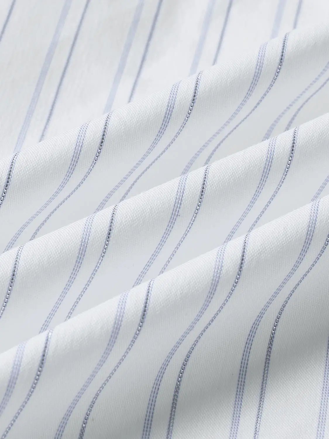 Shirt fabric with white background and thin blue vertical stripes.