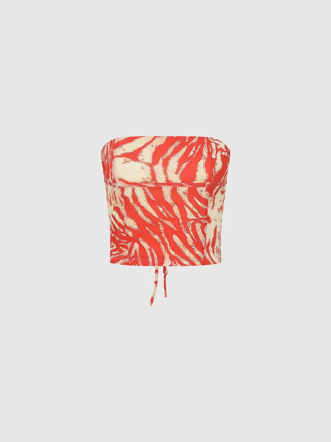 Bandeau top with red zebra-print pattern on cream background, adjustable drawstring hem.
