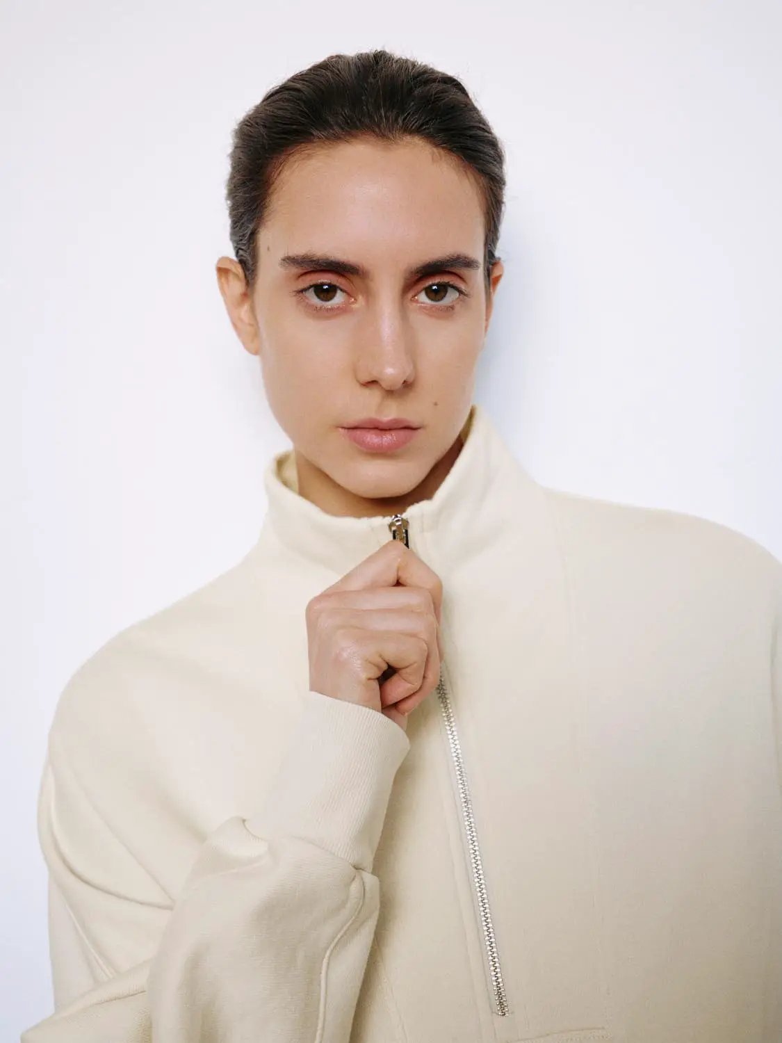 Sweatshirt by Urban Revivo Fashion in cream with front zip closure.
