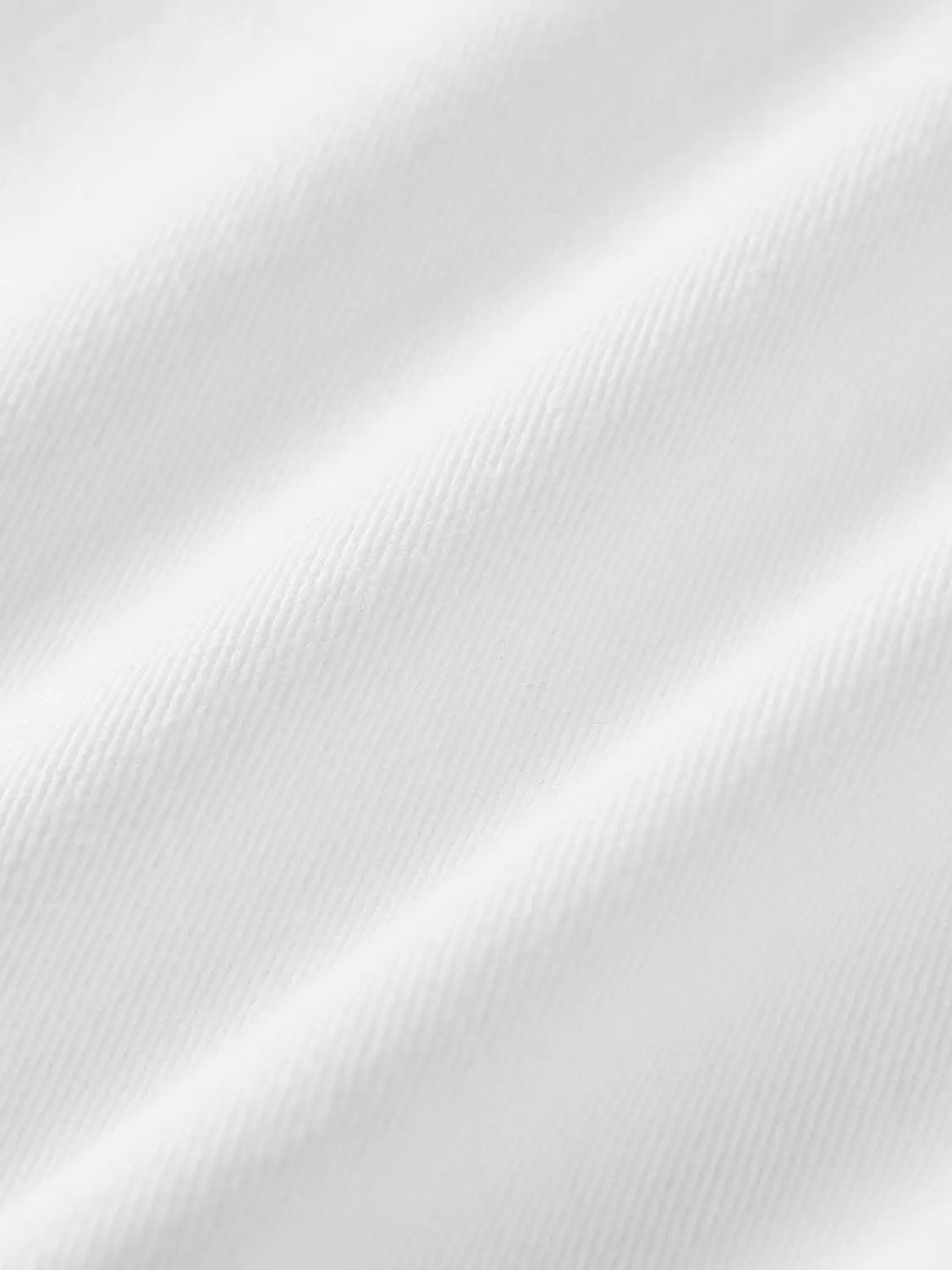 Layered overlay draped waist wide-leg cotton trousers fabric close-up in white