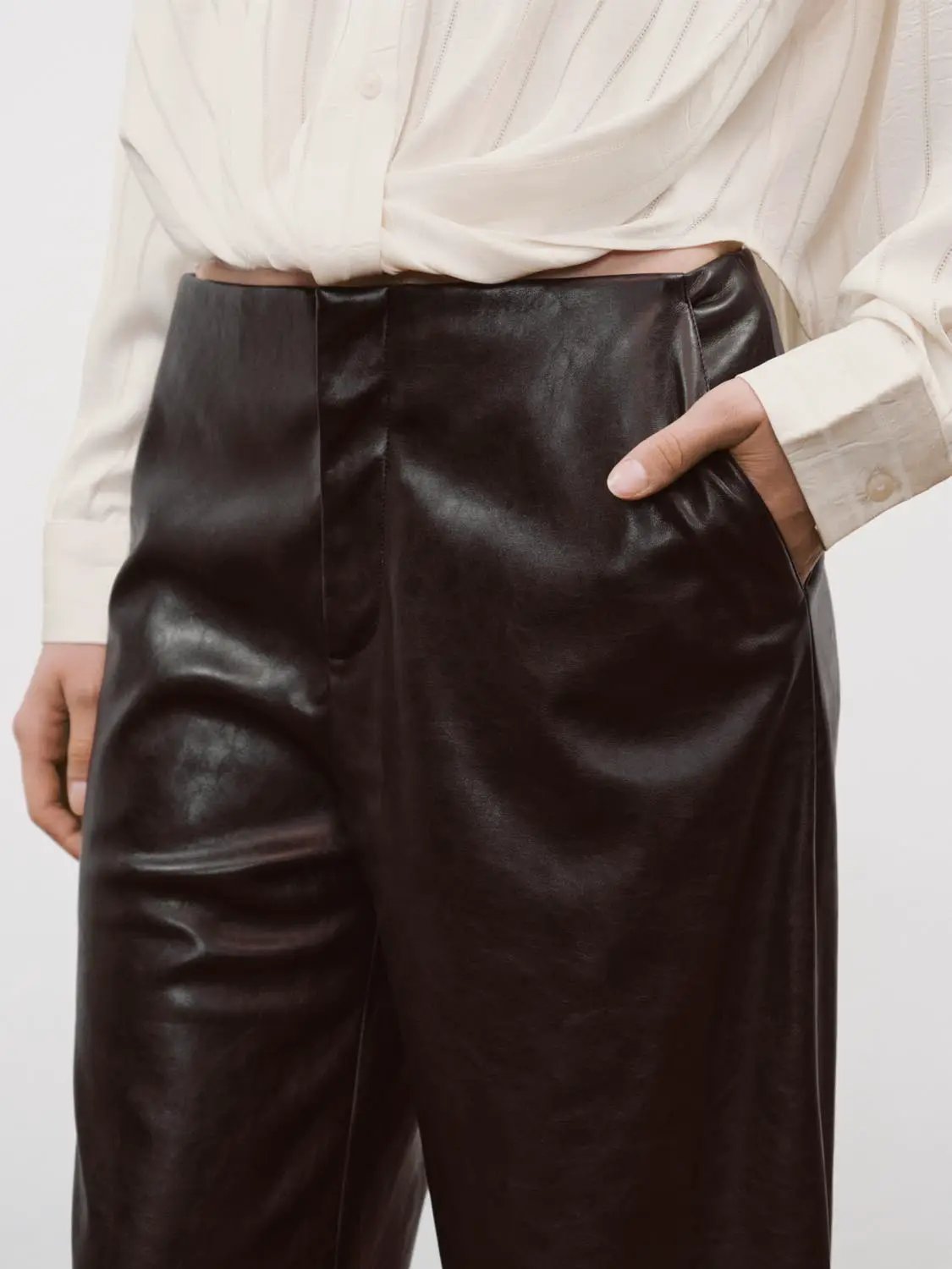 Mid-rise curved-leg faux leather pants by Urban Revivo Fashion in black, sleek leather-look finish.