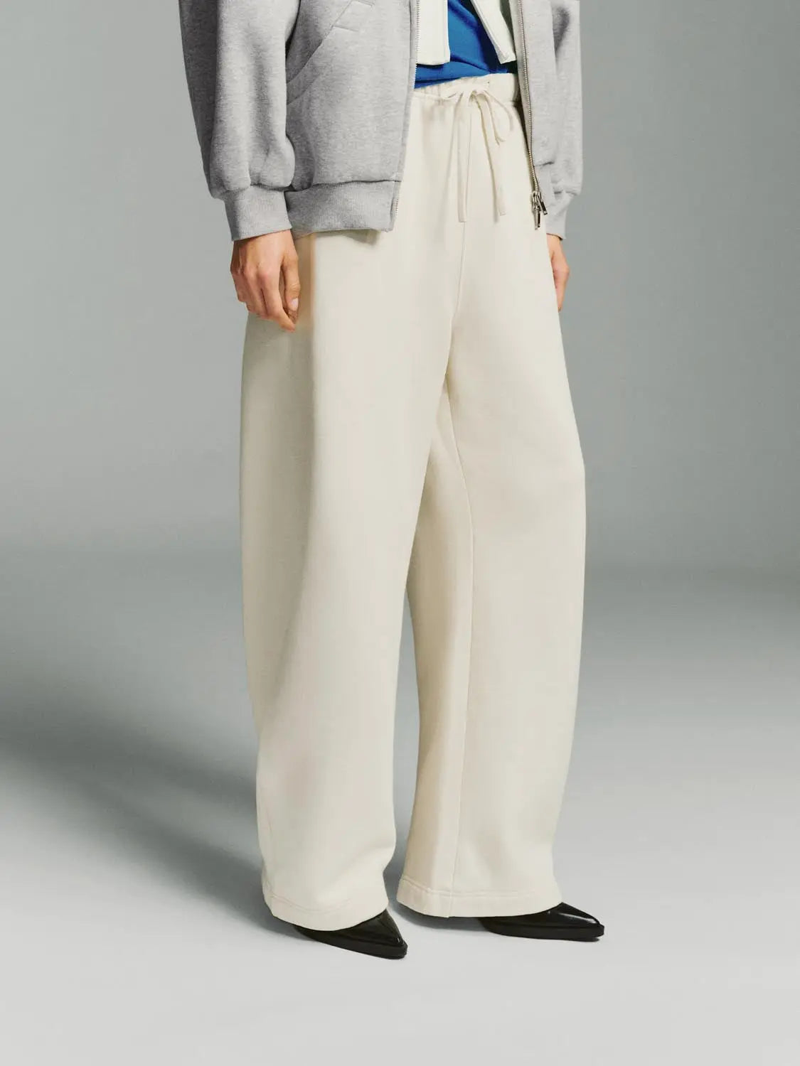 Wide-Leg Pants in cream with a drawstring waist by Urban Revivo Fashion.