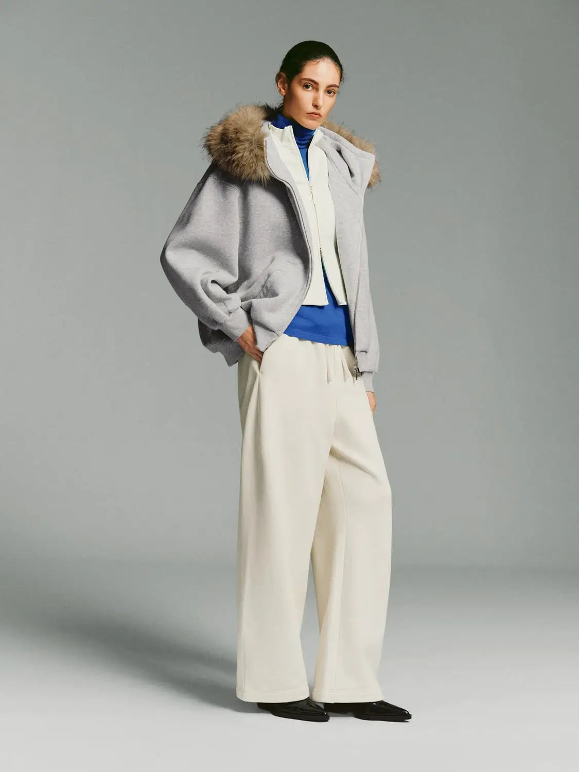 Wide-leg pants in cream by Urban Revivo Fashion, shown with a grey fur-trimmed coat for a two-piece look.