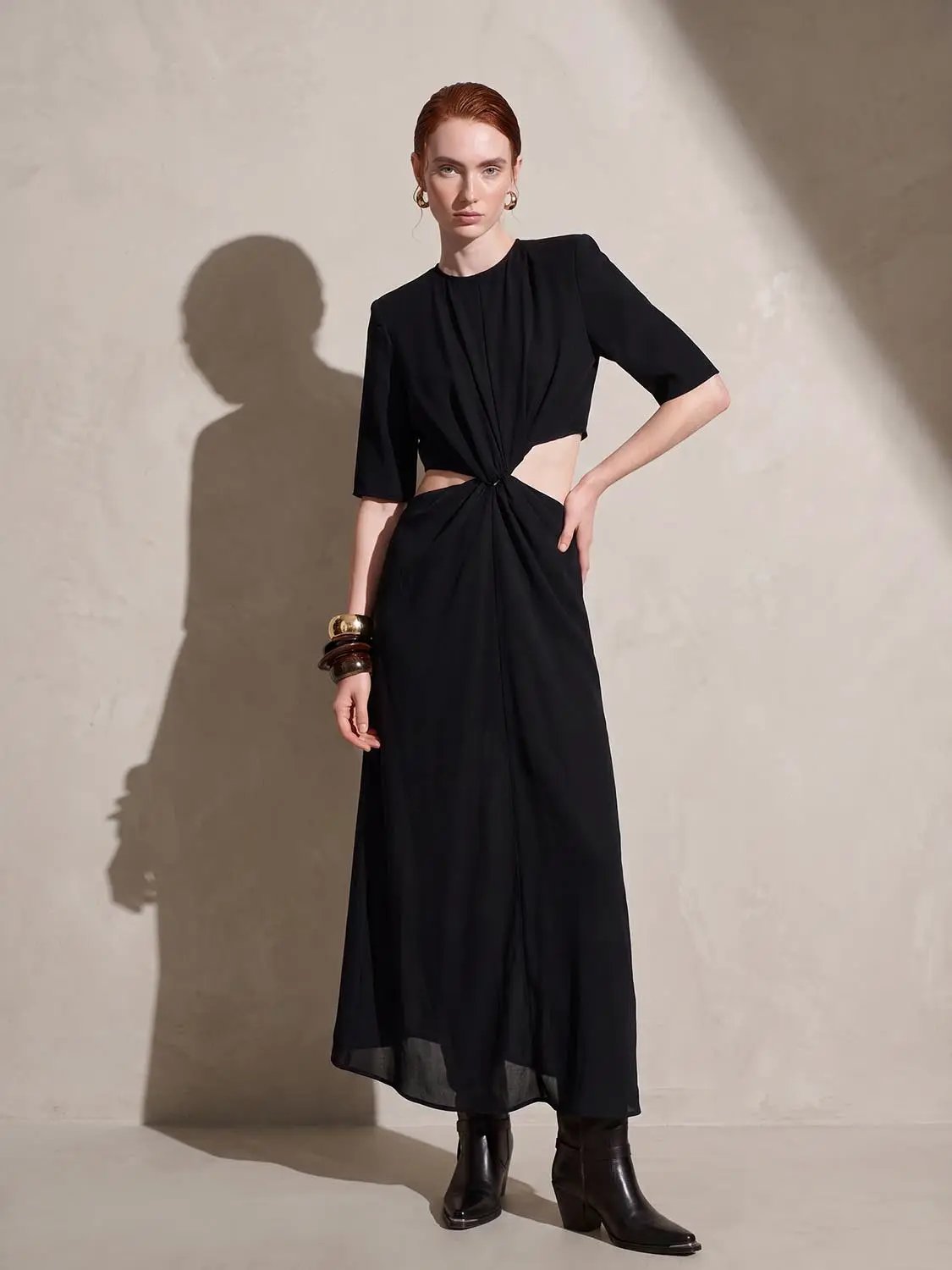 Black round-neck midi dress with a knotted waist and waist cutouts, short sleeves.