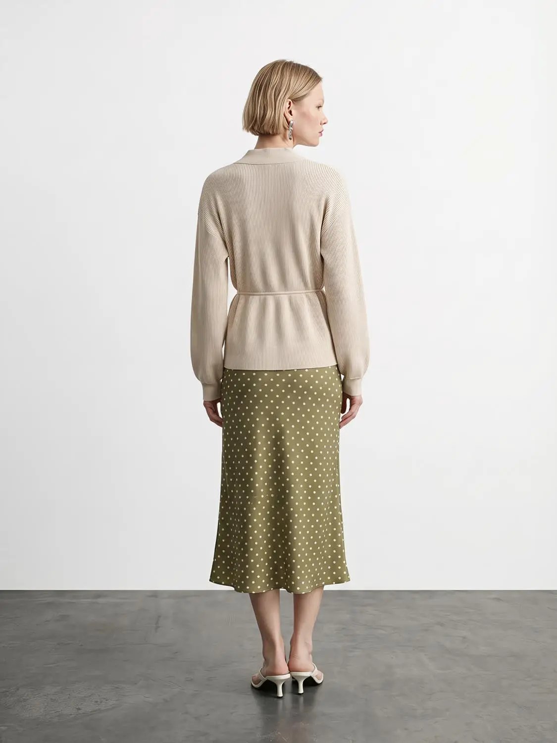 Zip-up balloon-sleeve knitted cardigan in beige with belted waist.