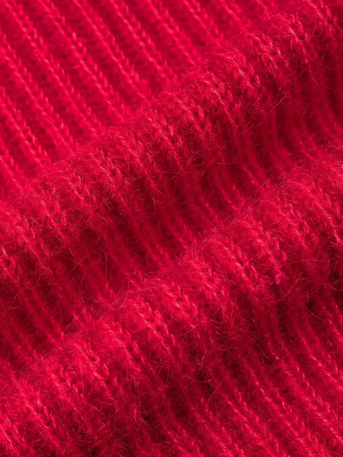 V-Neck long sleeve knitted T-shirt fabric in rich red yarn, close-up of soft ribbed knit texture and fibers