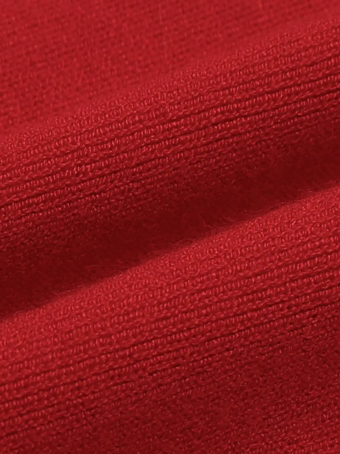 Red knitted T-shirt fabric close-up texture for knitwear