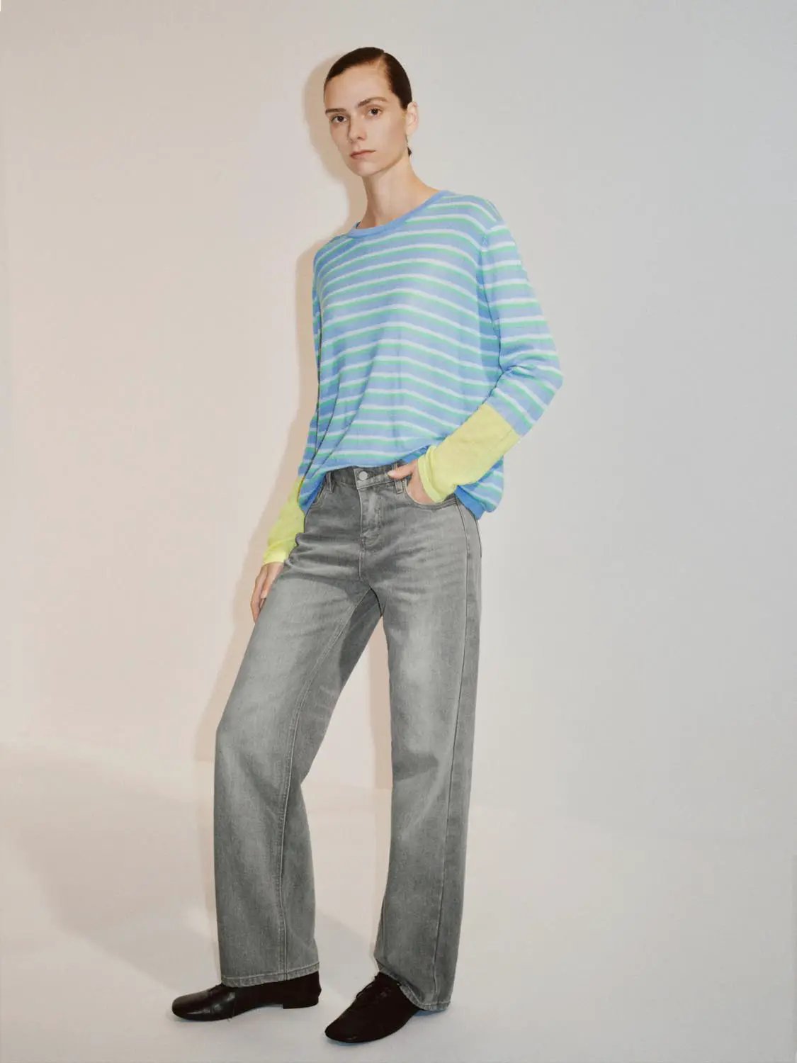 Color Block Striped Long Sleeve Crew Neck Sweater modeled in blue and mint stripes with neon yellow cuffs