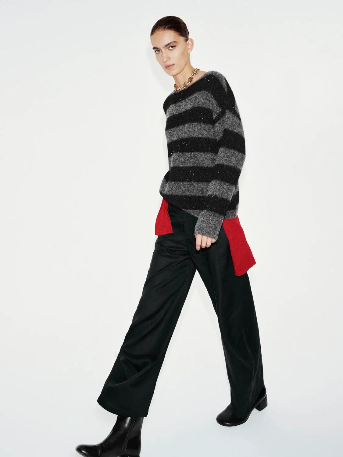 Textured striped oversized boat-neck long-sleeve sweater in black and gray knit.
