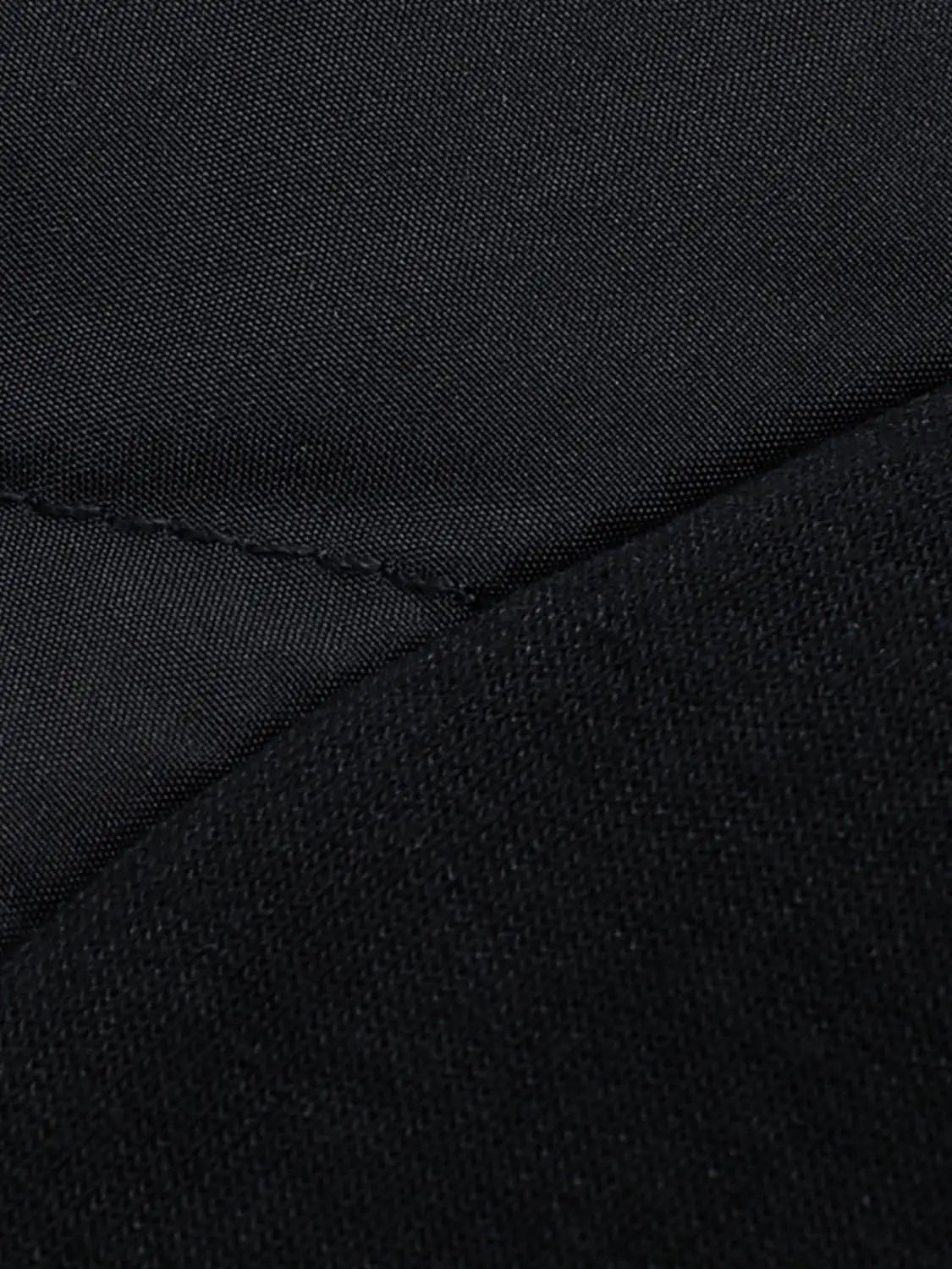 Down Jacket black fabric close-up showing seam and stitching detail