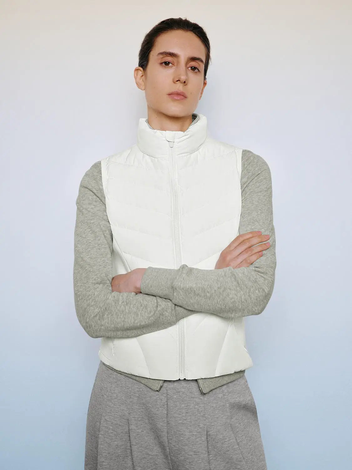 Down Jacket with white quilted body and gray sleeves, high collar and front zip