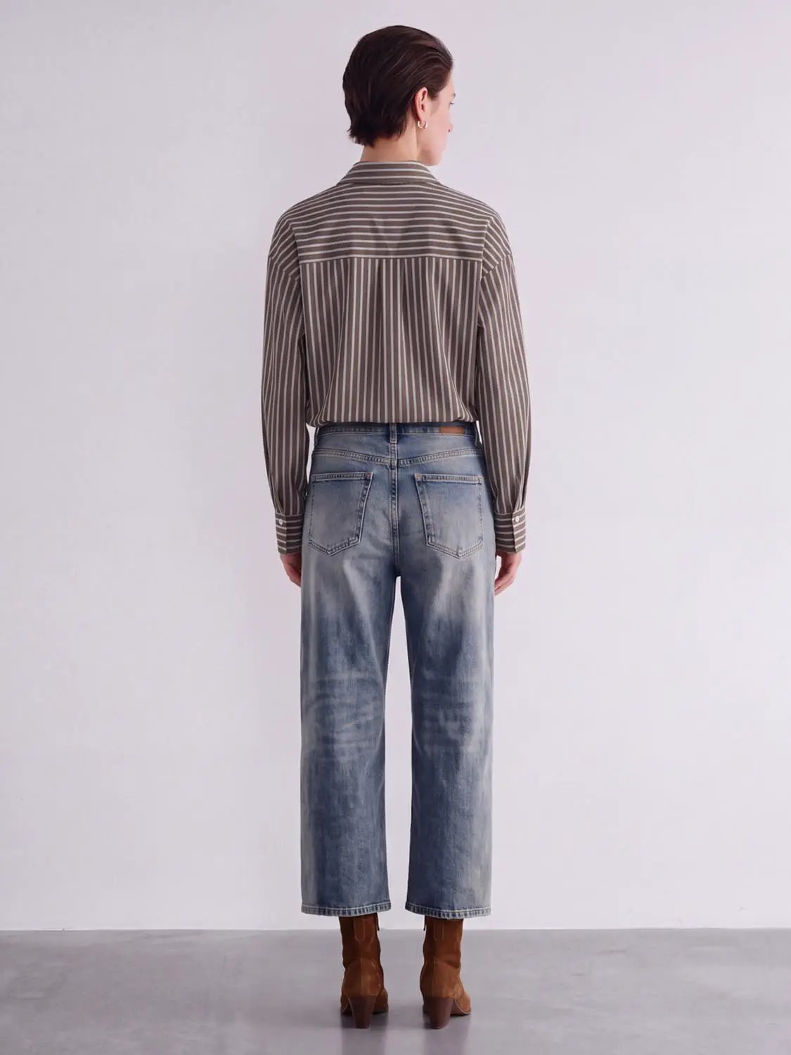 Striped button-up shirt shown from back; brown and beige tones, long sleeves.