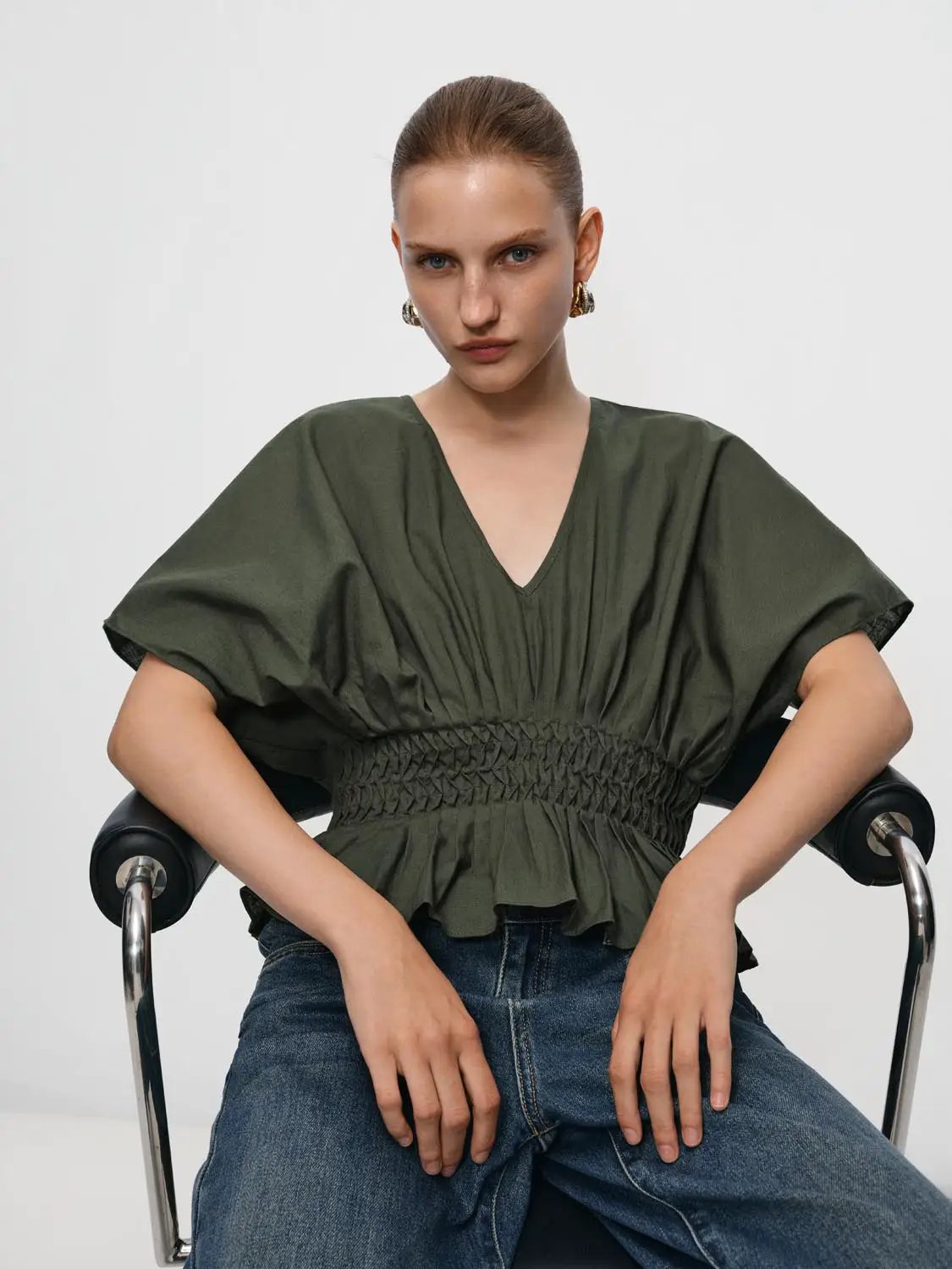 V-neck puff-sleeve blouse in olive green with smocked waist, cotton-linen blend
