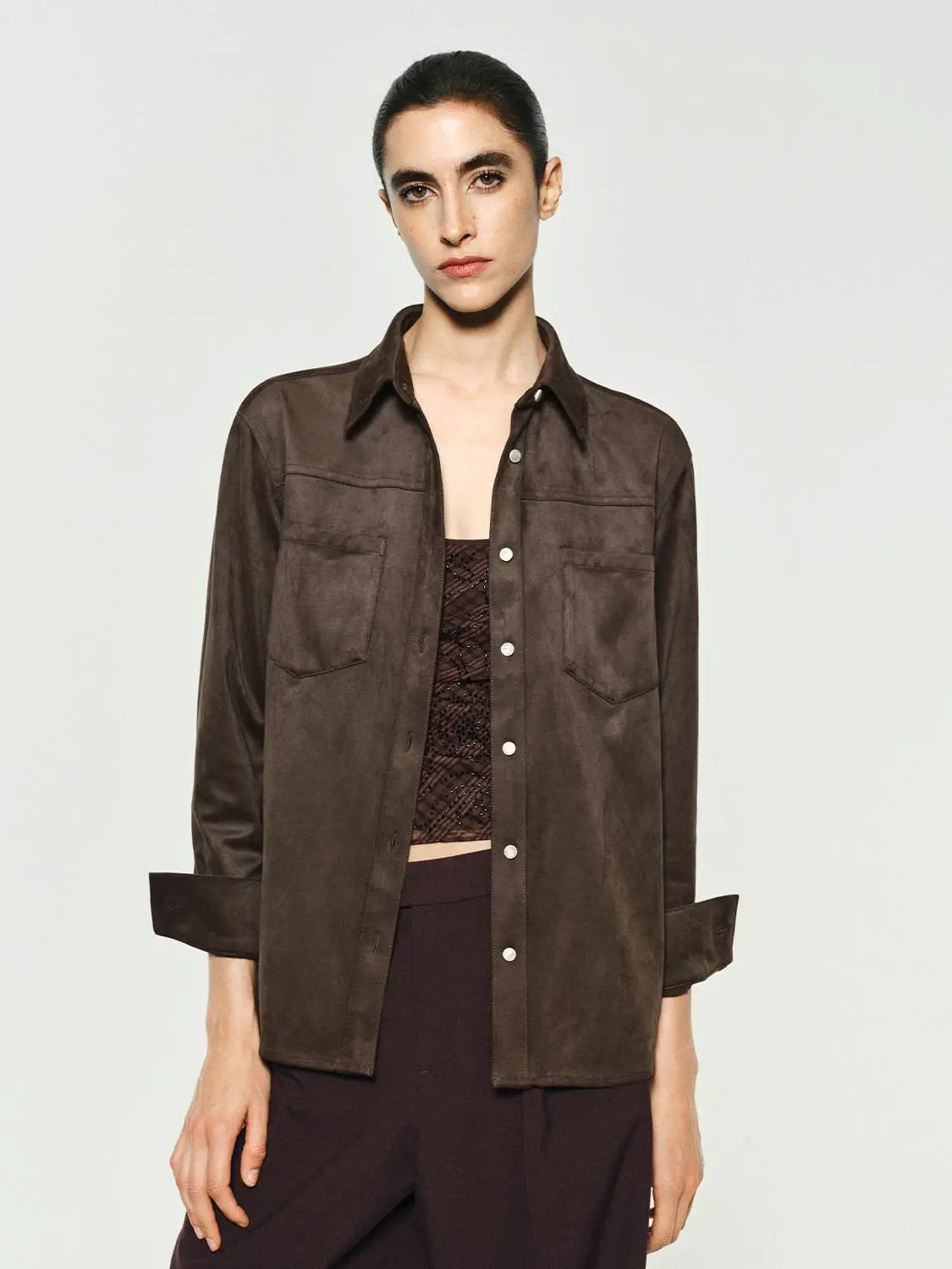 Brown button-down shirt with two chest pockets and rolled cuffs.