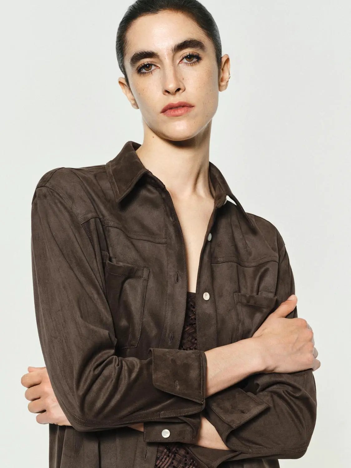 Button-down brown shirt with front chest pockets and metal buttons