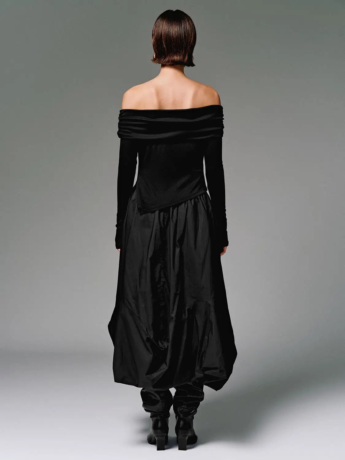 Off Shoulder Long Sleeve T-Shirts, black; back view of model wearing an off-shoulder top with a flowing black skirt.