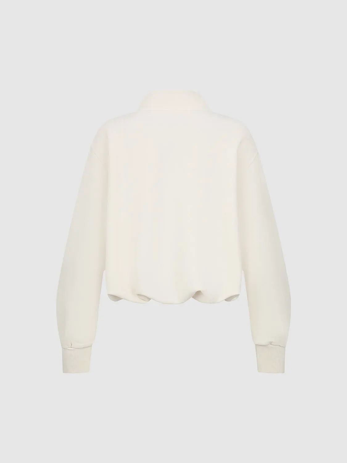 Cream sweatshirt back view with ribbed cuffs and long sleeves.