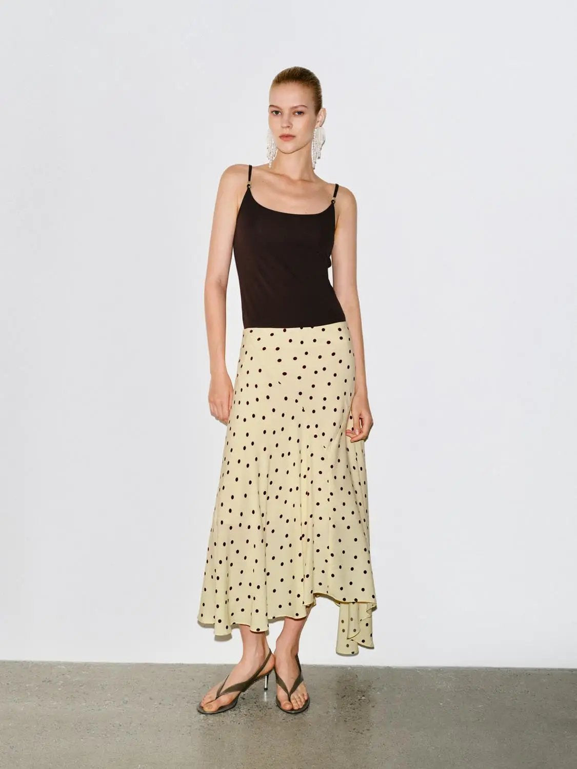 Polka dot asymmetric-hem maxi wrap skirt in beige with black dots on model