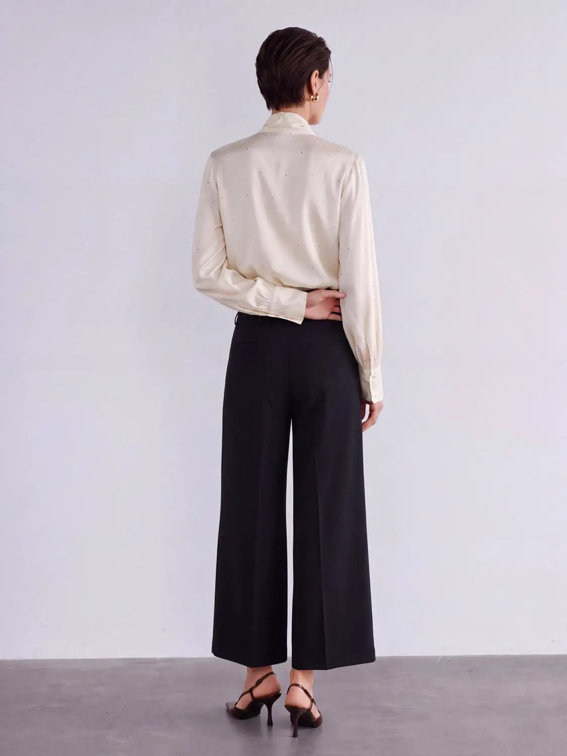 Wide-leg pants in black, back view with tailored high-waist fit