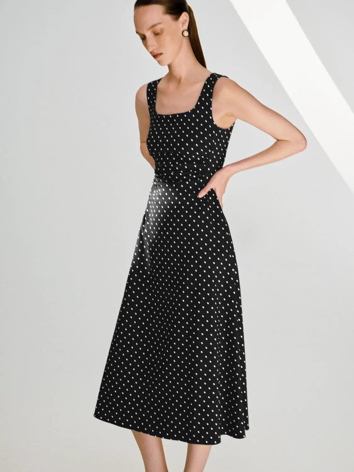 Polka dot knit sleeveless A-line dress in black with white dots