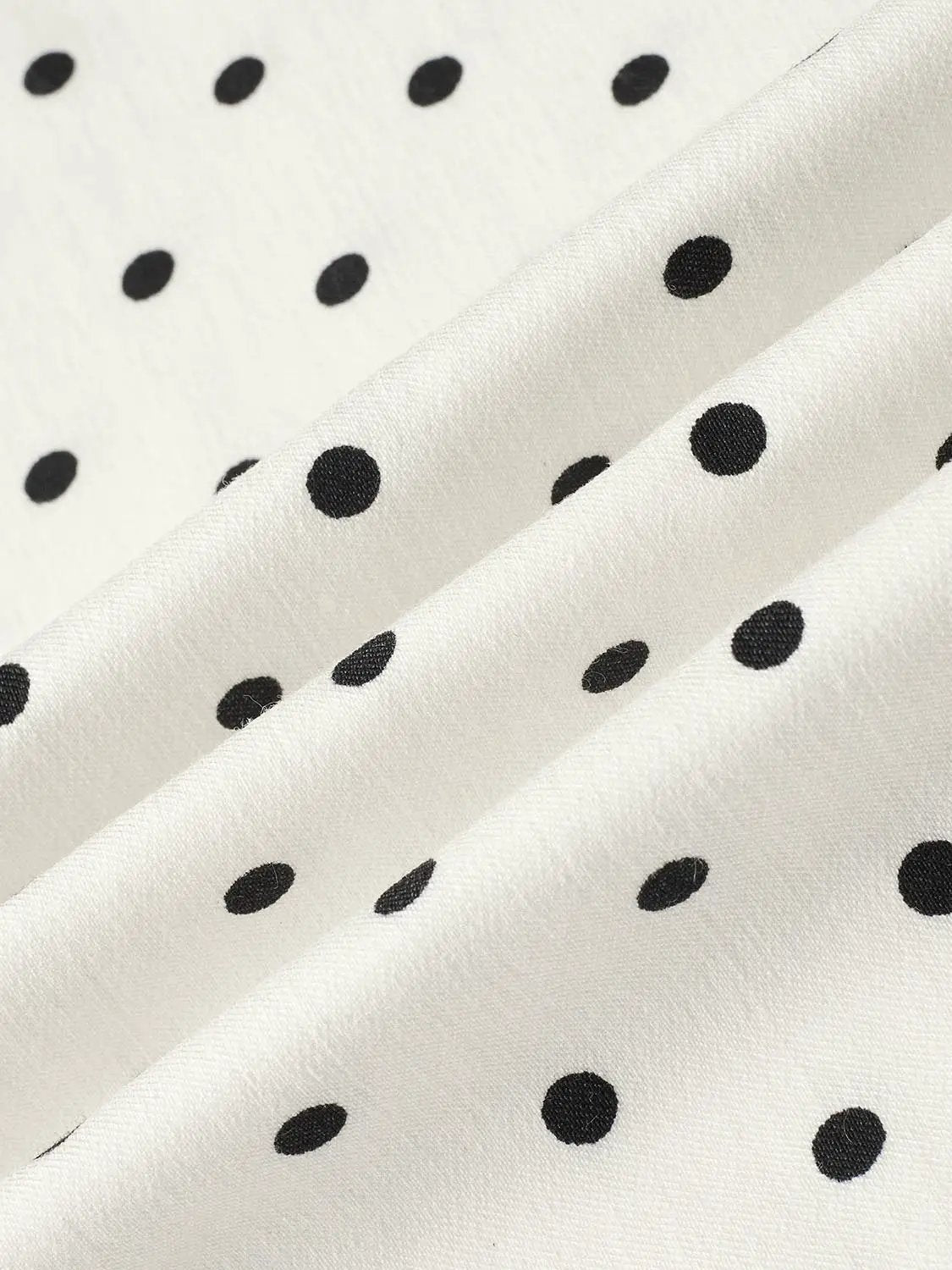 Polka dot knit A-line dress fabric in white with black spots