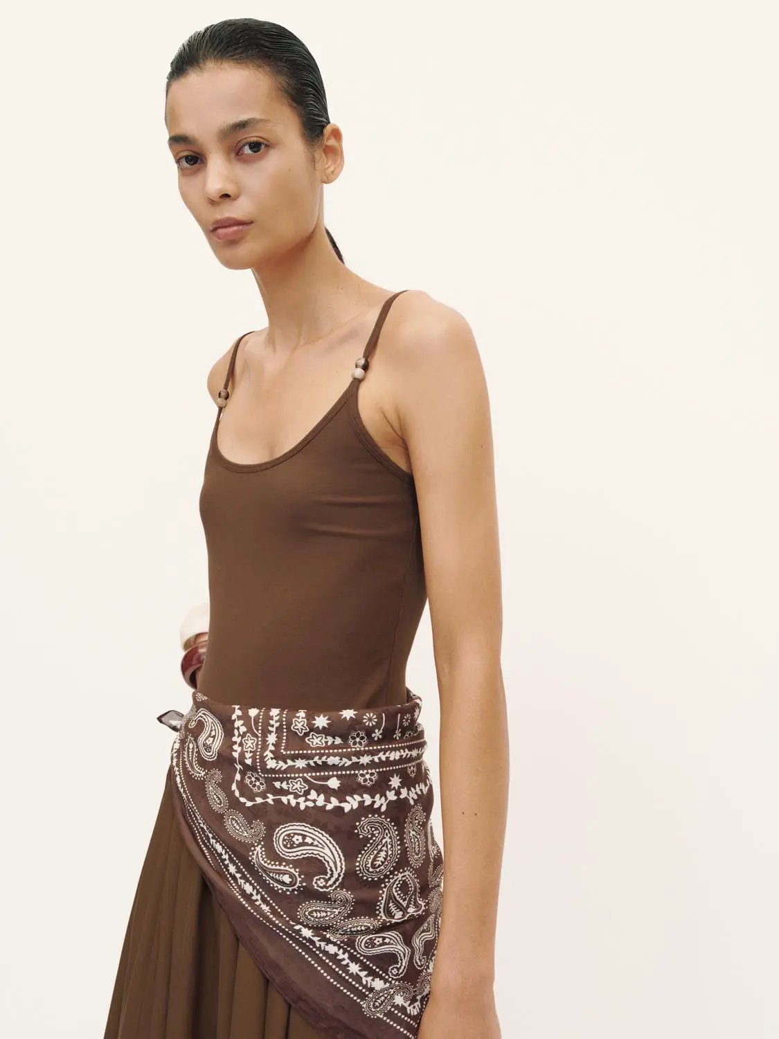 A-Line dress in brown with thin spaghetti straps and paisley scarf belt.