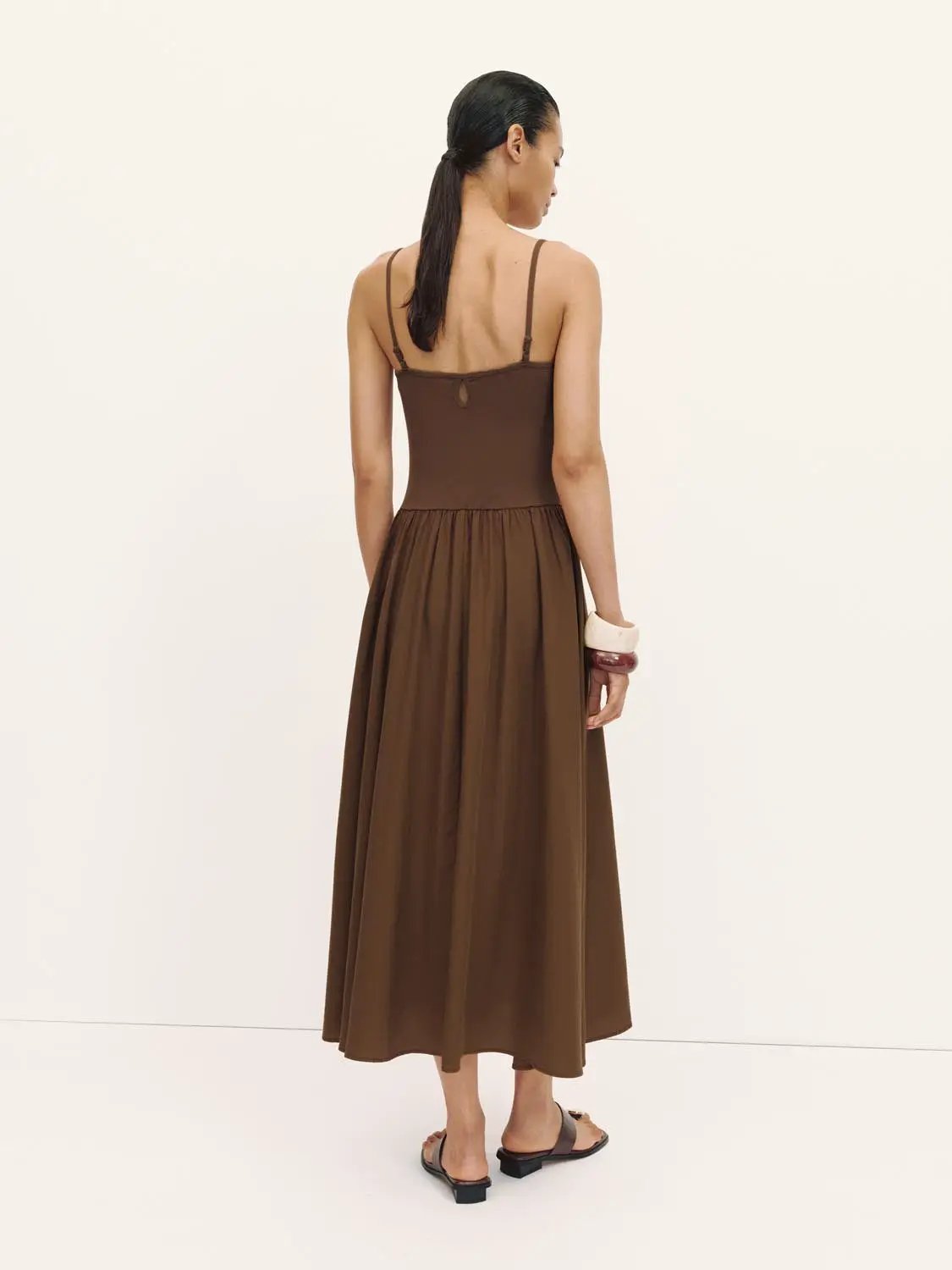 A-line brown dress with spaghetti straps, back view, midi-length.