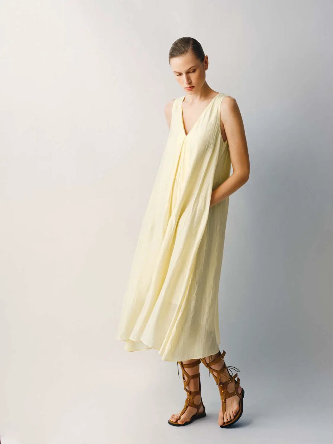 Slight Stretch A-Line Dress in pale yellow thin fabric, sleeveless with V-neck.