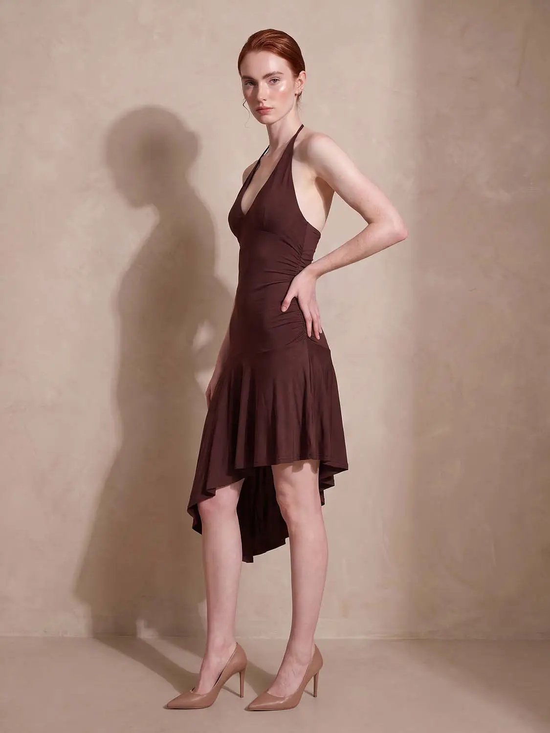 A-Line dress in brown with halter neckline and high-low hem.