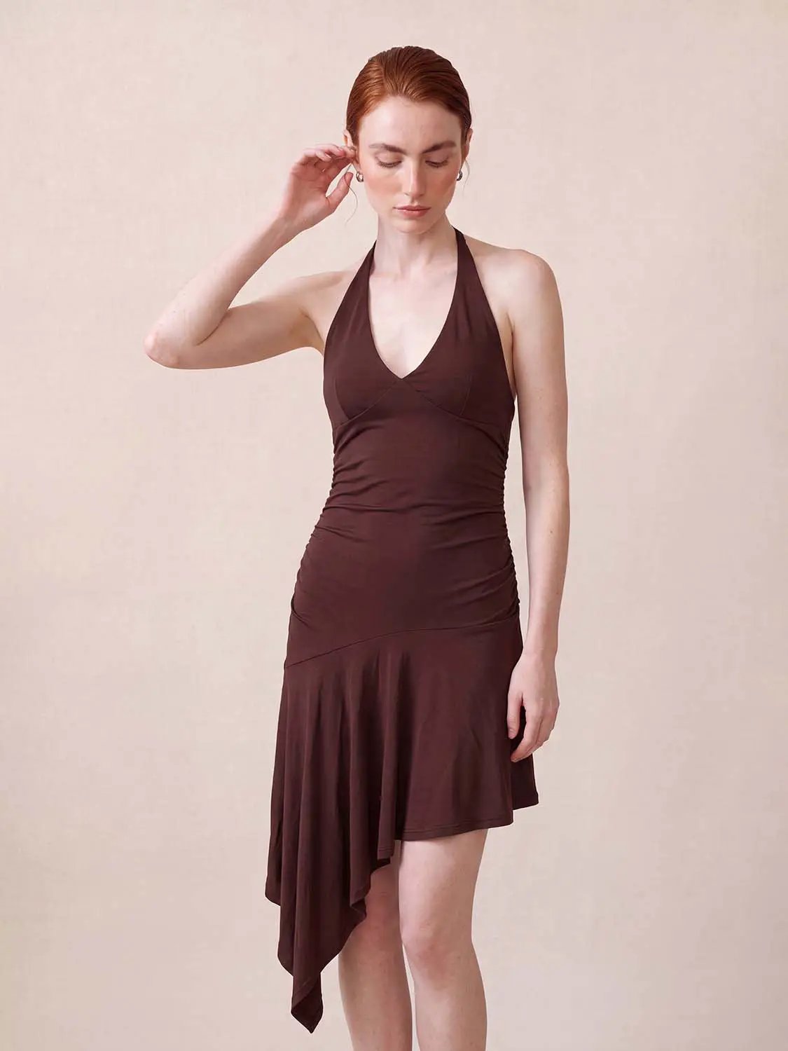 A-Line Dress in brown with halter neck, ruched waist, and asymmetric handkerchief hem