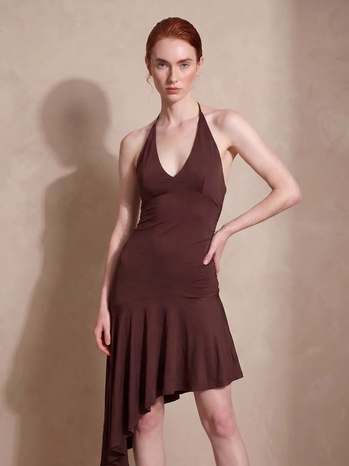 A-Line dress in brown with halter-neck, ruched bodice and asymmetric high-low hem.