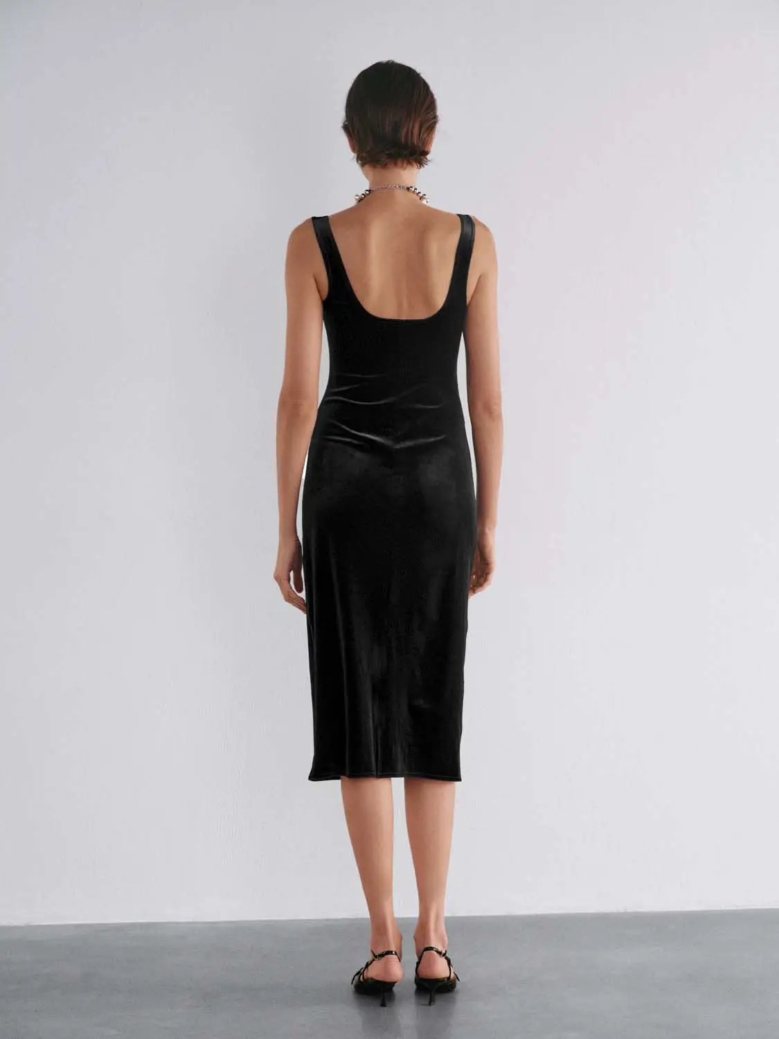 Ruched straight-square-neck sleeveless black velvet midi dress, back view