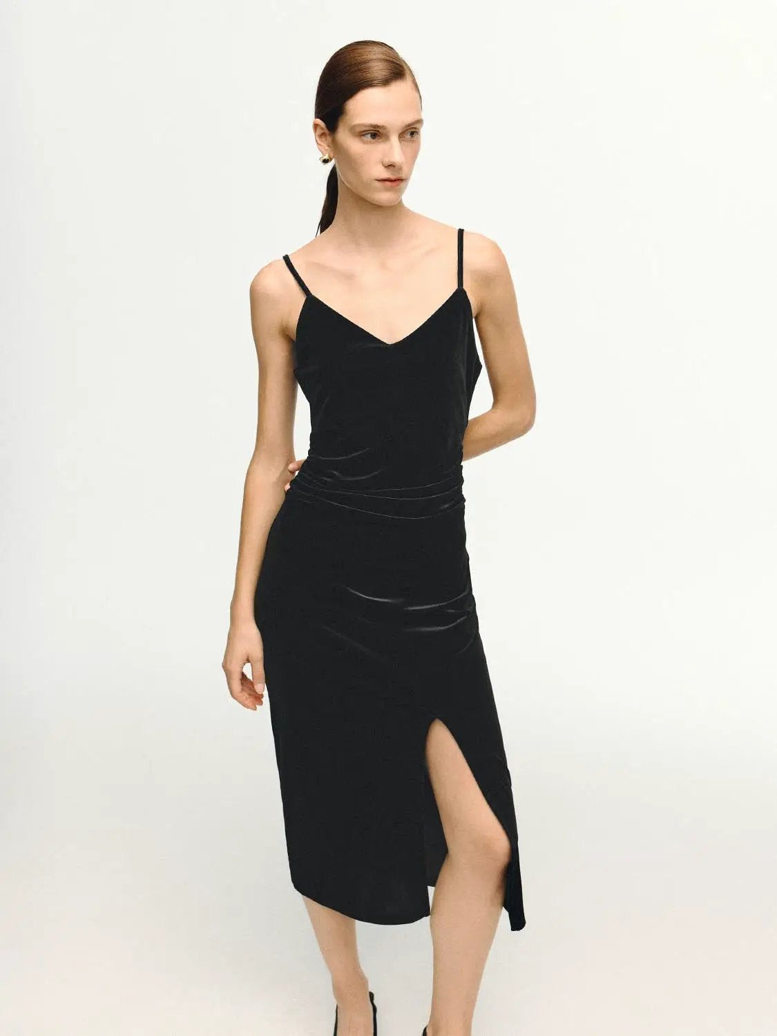 Sleek Spaghetti-Strap Midi Slit Dress, black velvet fabric with a side slit and ruched waist.