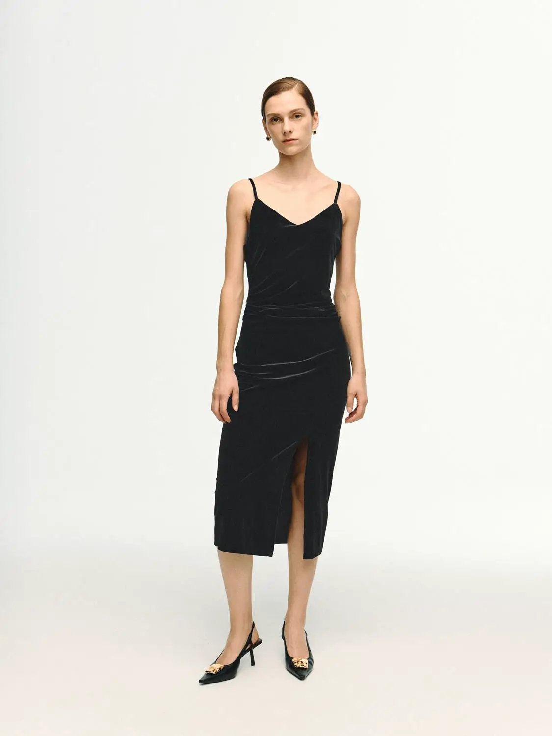 Sleek spaghetti-strap midi slit dress in black velvet.
