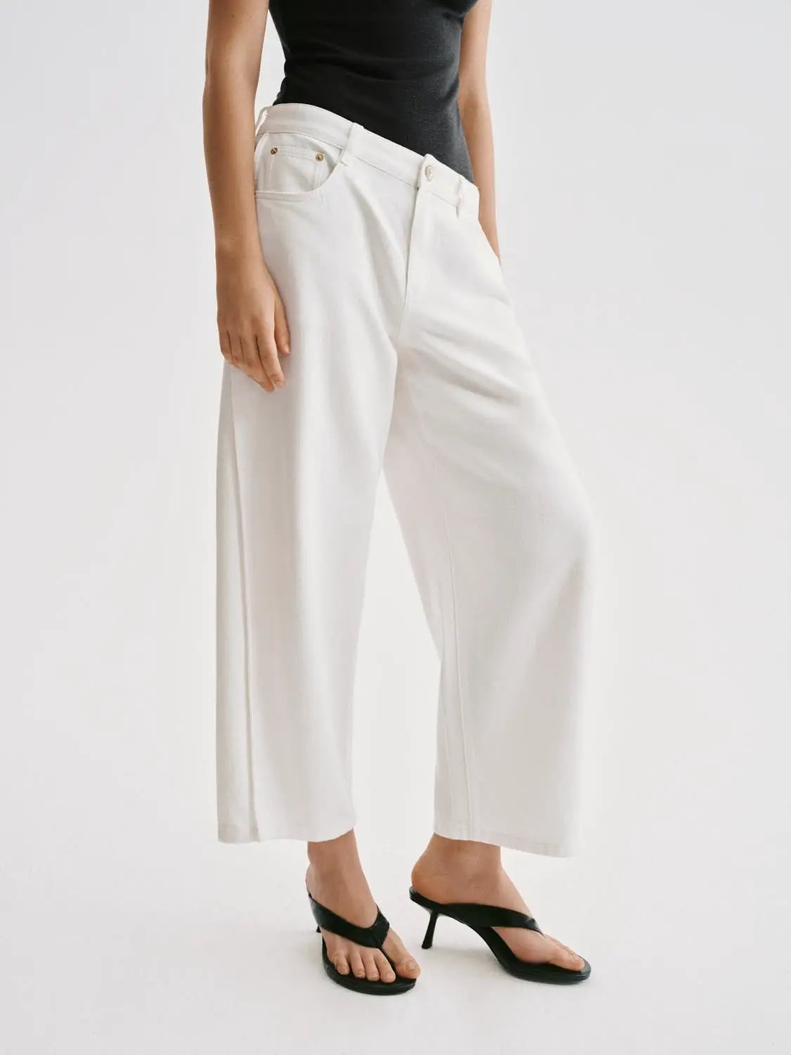 Casual relaxed wide-leg cotton-blend pants in white; ankle-length with front pockets