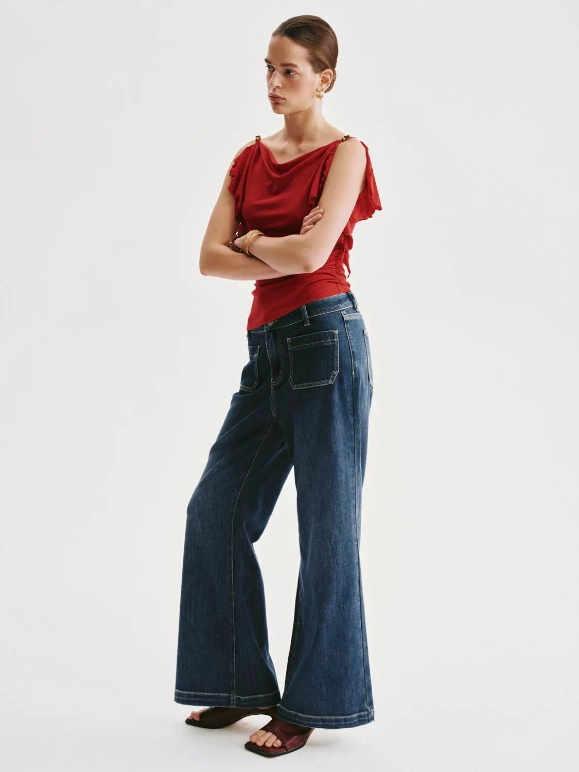 High-waisted patch-pocket wide-leg jeans in dark indigo denim worn by a model