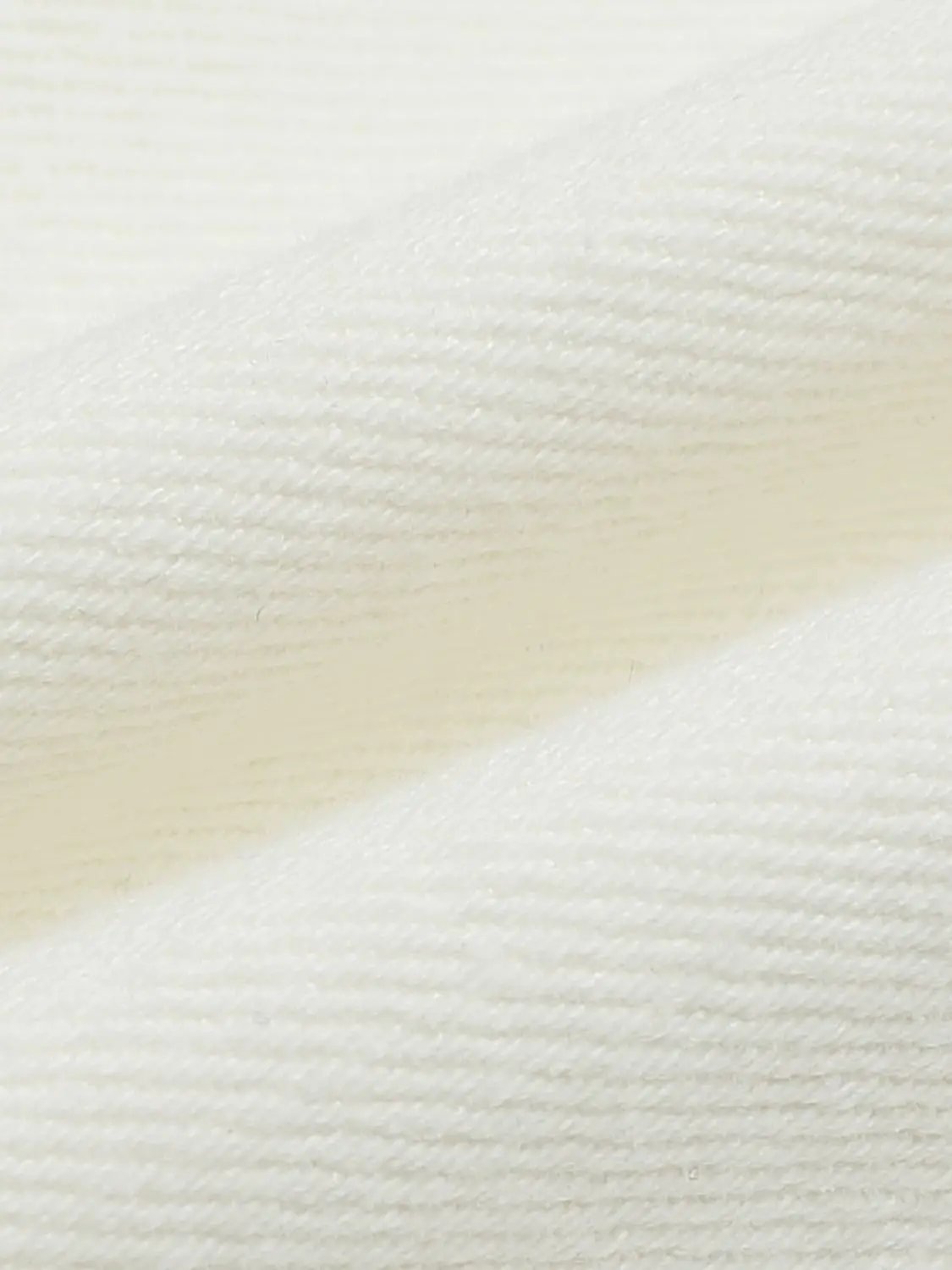 Casual jeans fabric in white denim twill texture, close-up view