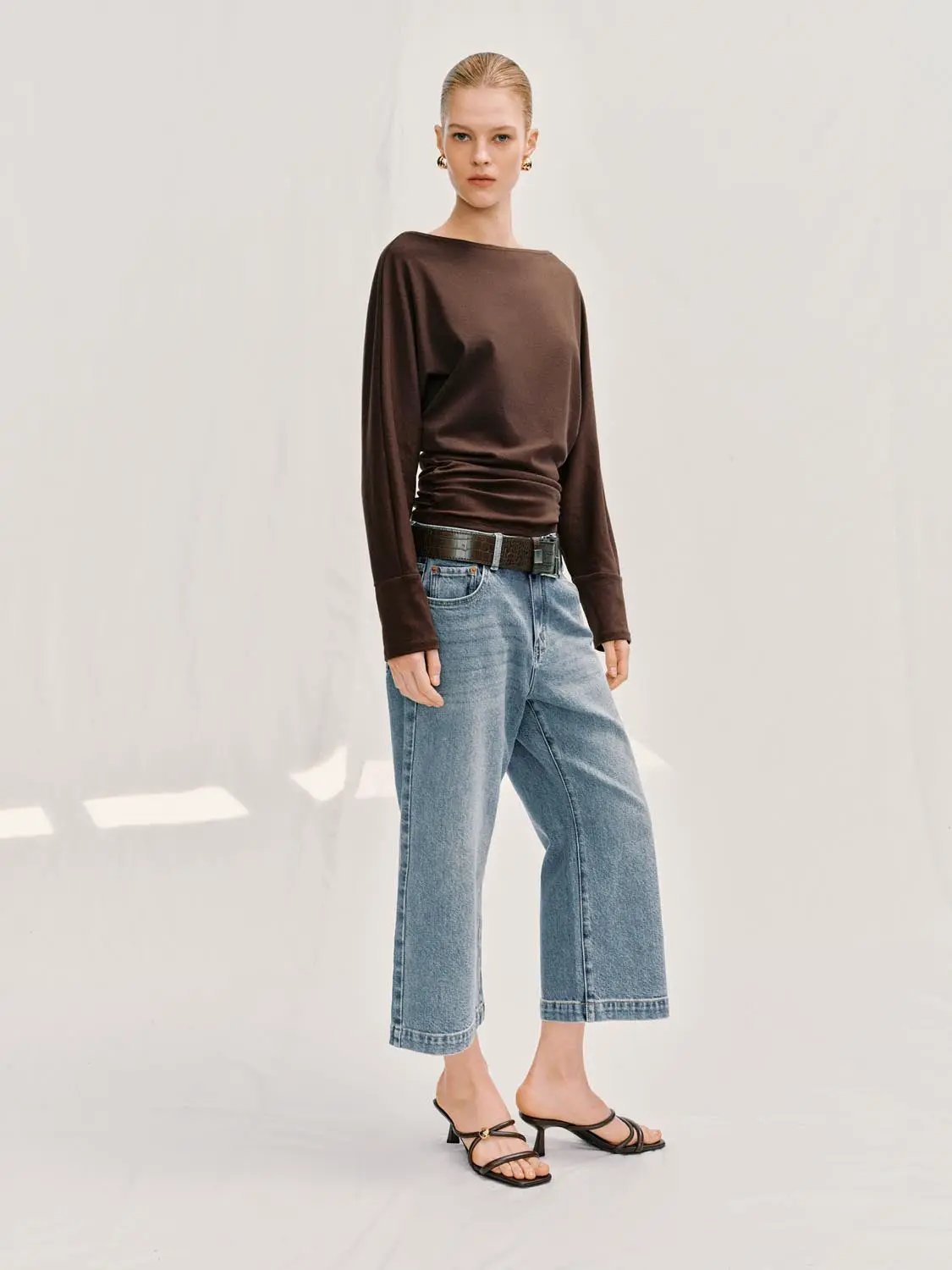 Jeans by Urban Revivo Fashion; light-wash wide-leg denim with belt on model.