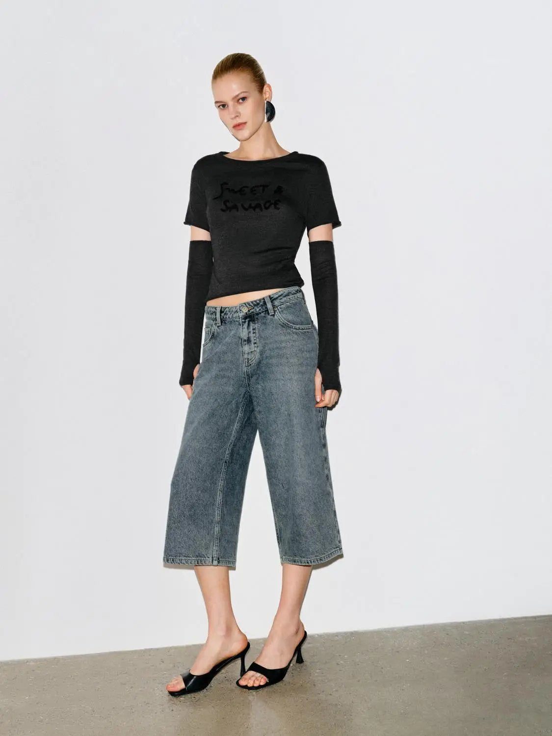 Relaxed High-rise Wide-leg Capri Cotton Jeans in light-wash denim.